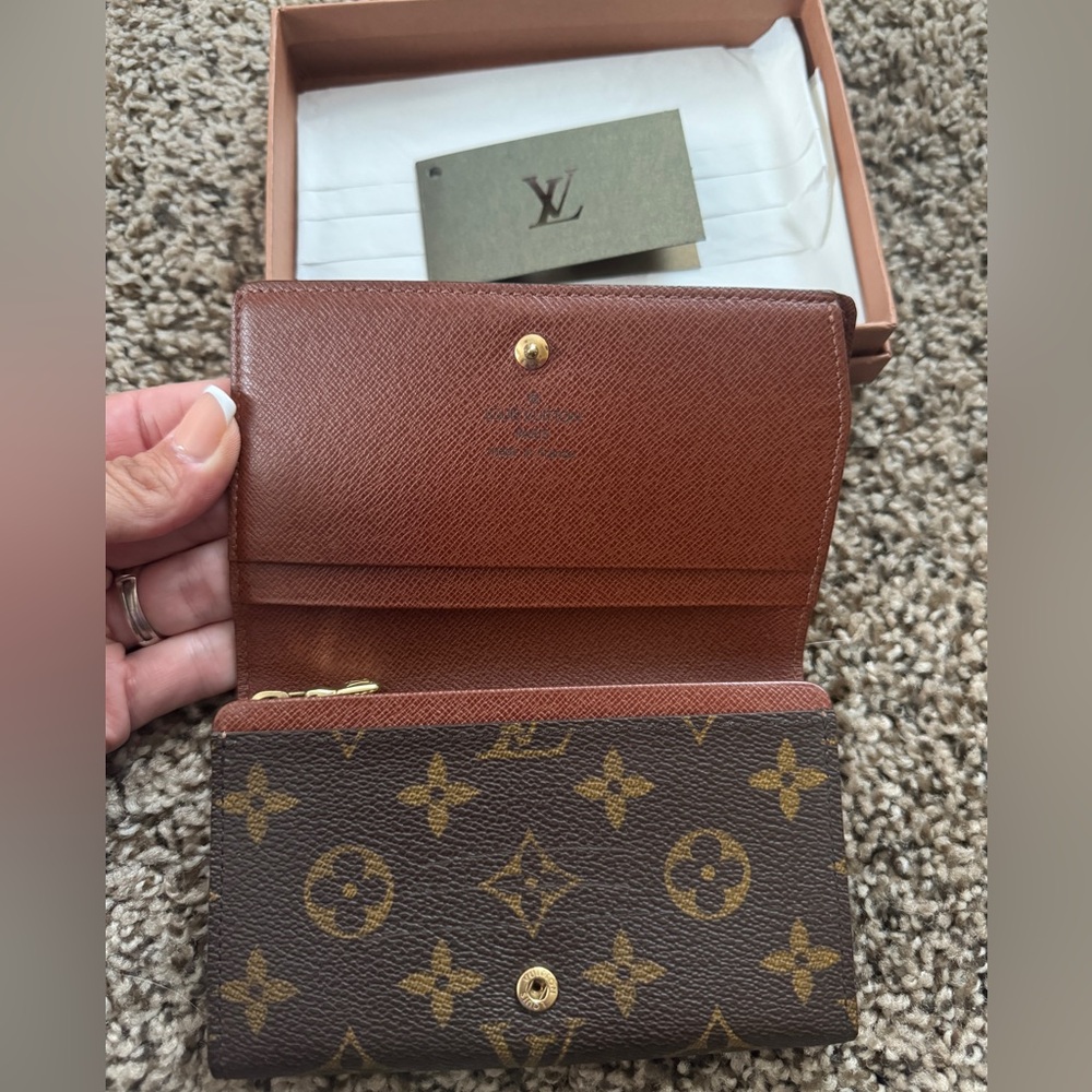 Authentic Louis Vuitton small wallet with side compartment for bills. With box